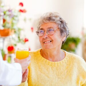 A woman drinking orange juice.